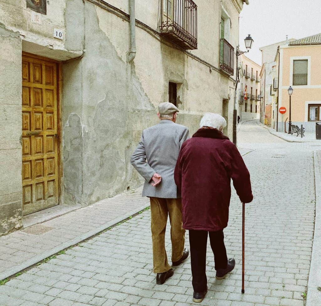 Elderly couple walking outdoors, illustrating the need for GPS trackers for elderly parents who wander